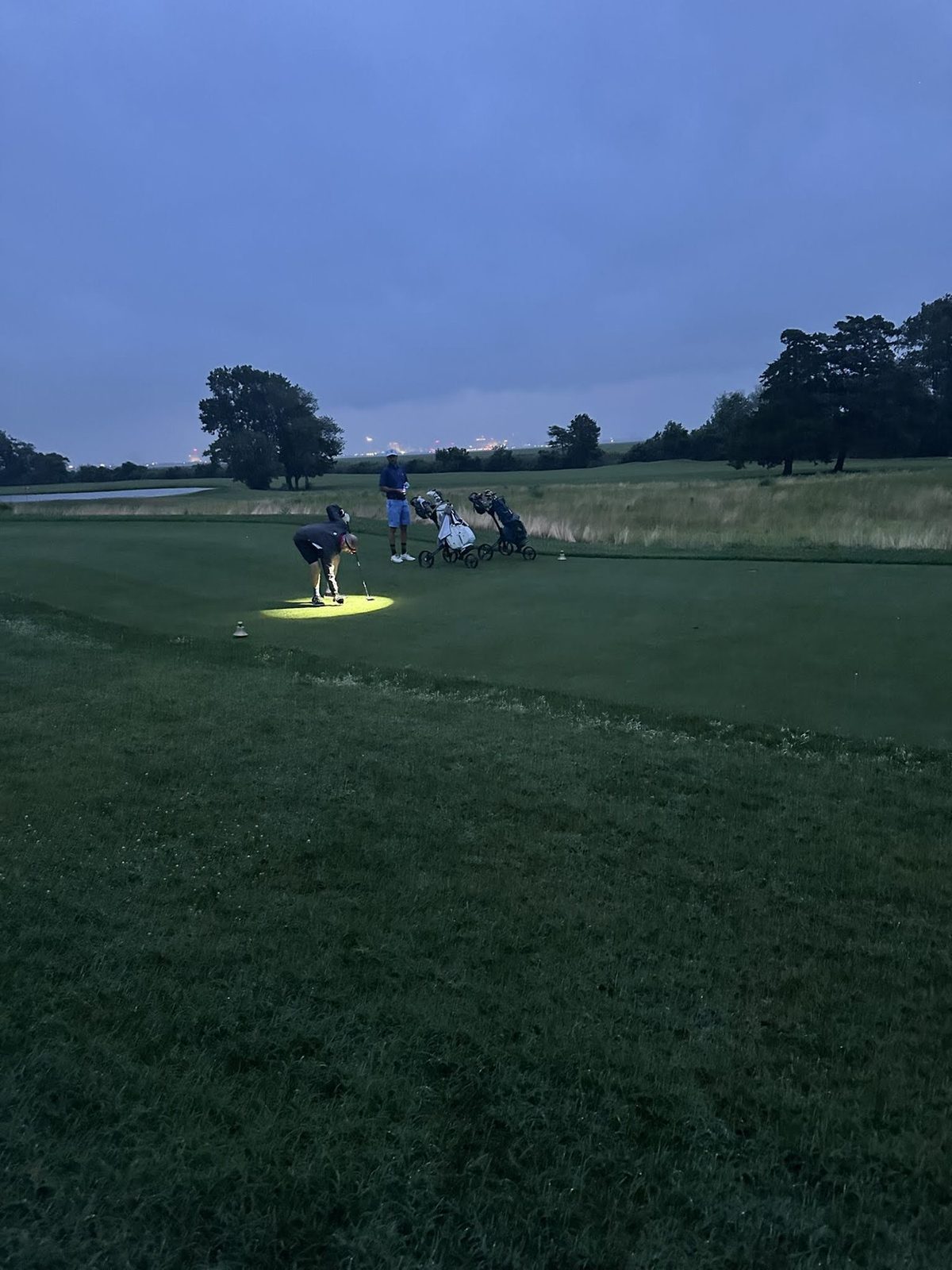 A glowing light on the green after dark